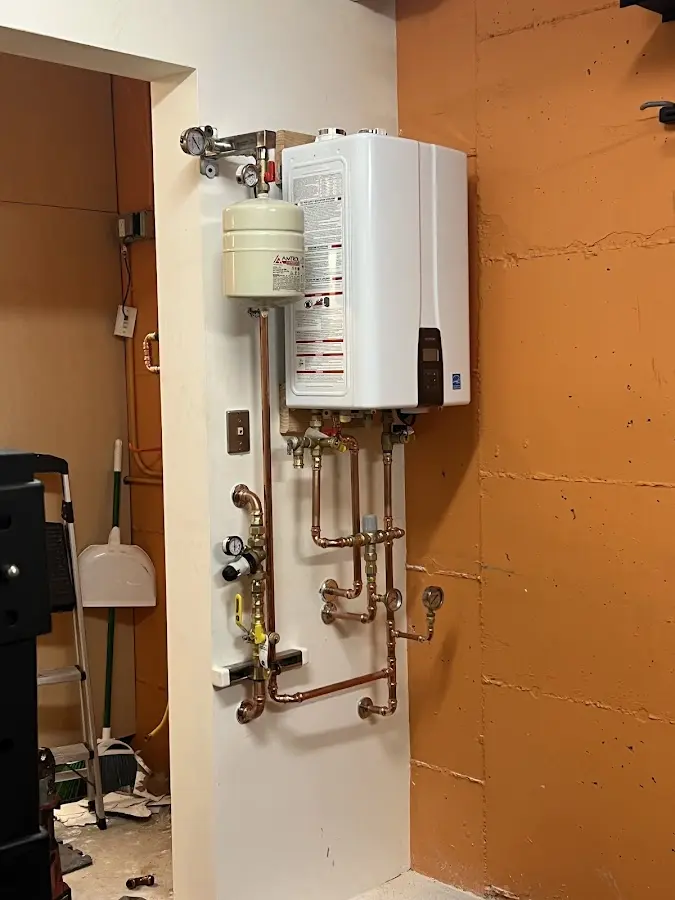 Plumbing technician inspecting water heater connections in Carrollwood